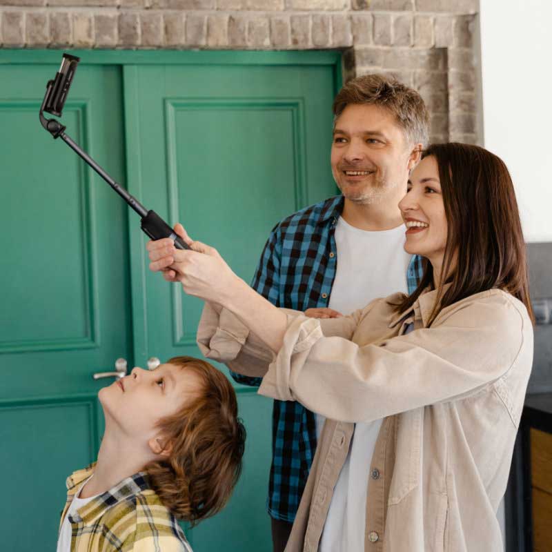 Family taking a selfies at the front door.