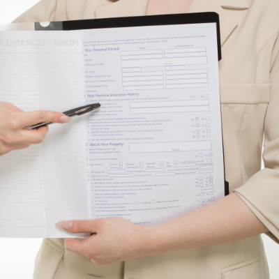 Filing Insurance Claim Holding Paperwork